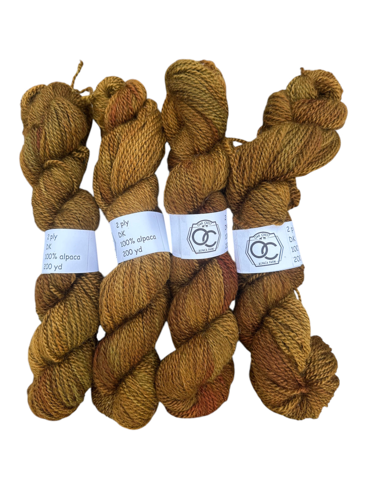 Oak Crest Alpacas and More hand-dyed 100% American alpaca DK yarn skeins in a variegated brown and gold tone