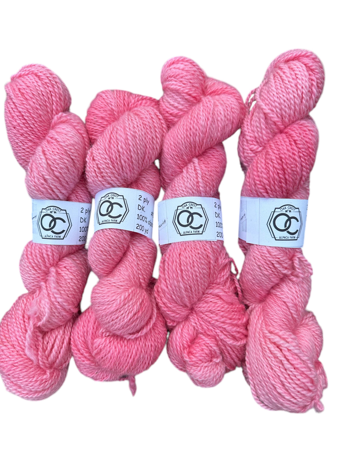 Four skeins of hand dyed pink 100% American Alpaca DK yarn from Oak Crest Alpacas and More with dehaired soft fiber.