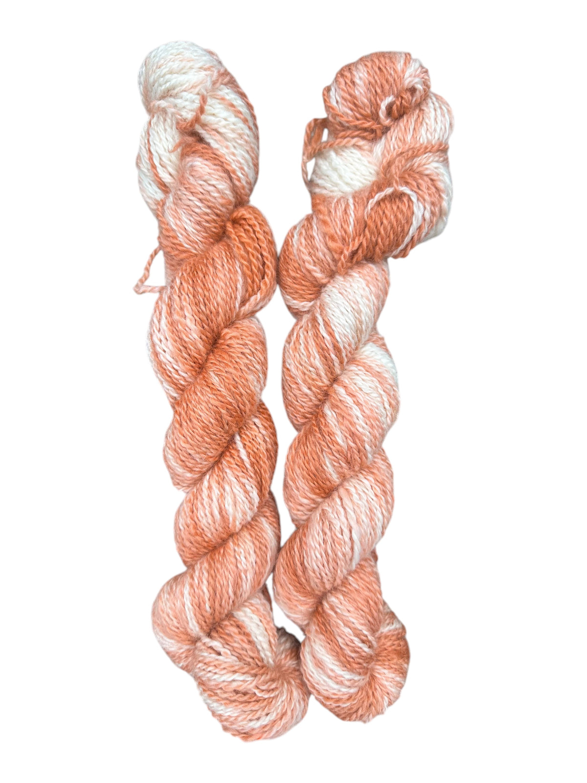 Oak Crest Alpacas and More hand-dyed DK weight 100% American alpaca yarn in a variegated peach and white 2-ply skein.