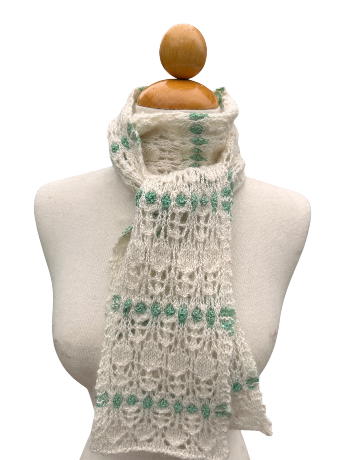 Oak Crest Alpacas and More hand knit white and green lace alpaca scarf on a mannequin