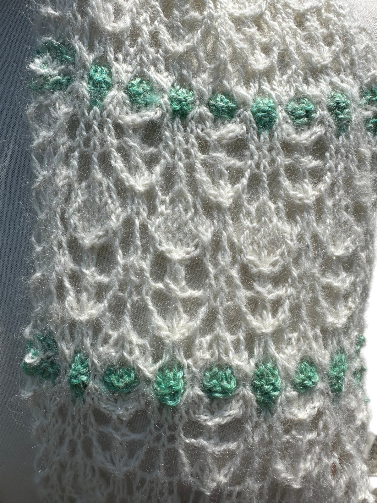 Oak Crest Alpacas and More hand knit alpaca scarf featuring a delicate white lace pattern with green accents.