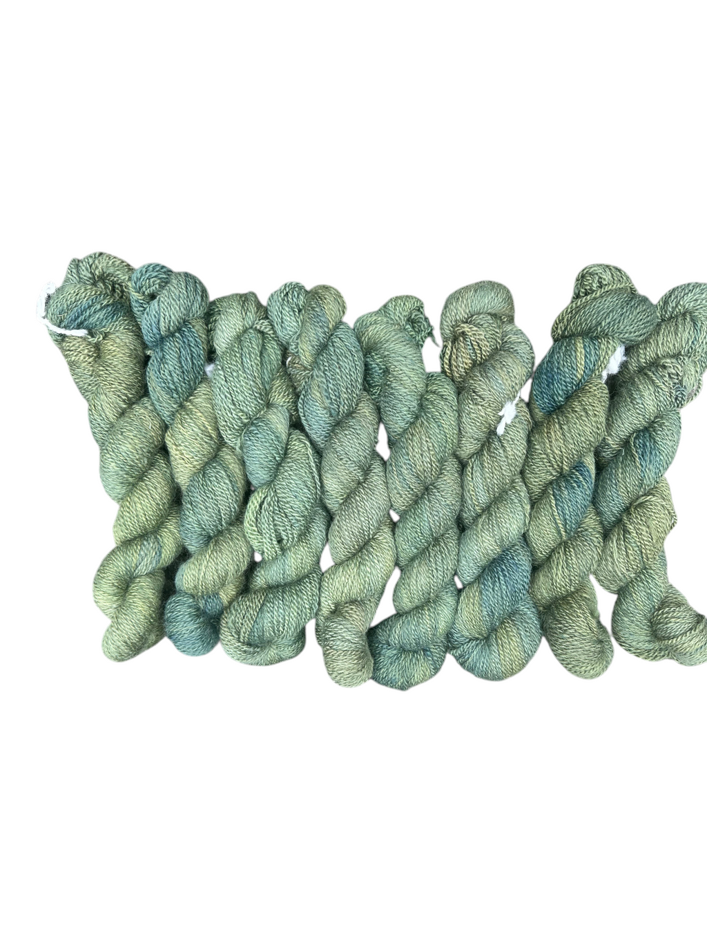 Oak Crest Alpacas and More hand dyed 100% American alpaca DK yarn in variegated sage green and blue tones.