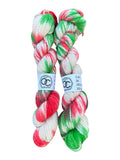 Oak Crest Alpacas and More hand dyed DK weight 100% alpaca yarn skeins in festive red, green, and white colors.