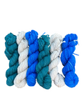 Oak Crest Alpacas and More worsted weight alpaca yarn skeins in blue, teal, and cream for a Fair Isle knitting kit.
