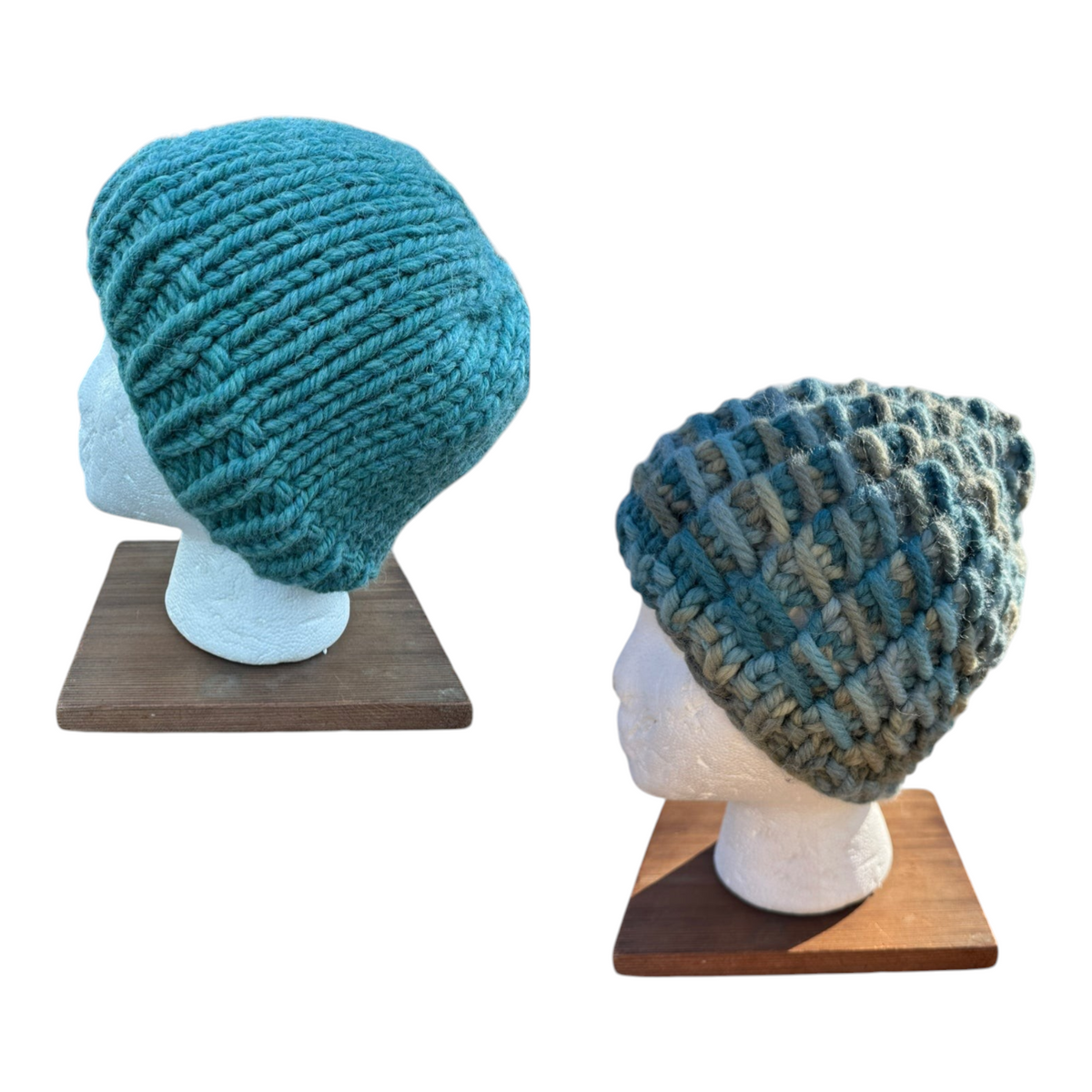 Oak Crest Alpacas and More chunky knit teal alpaca and wool hats on mannequin heads showing solid and variegated yarn