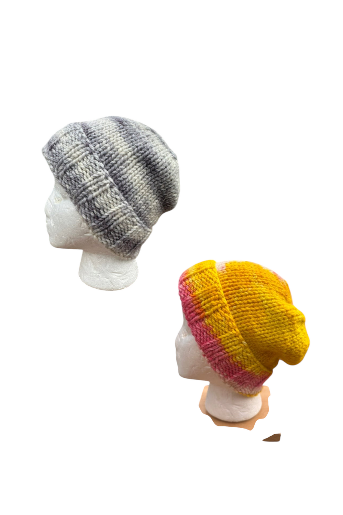 Oak Crest Alpacas and More hand knit alpaca and merino wool slouch hats in lavender-gray and pink-yellow colorways.