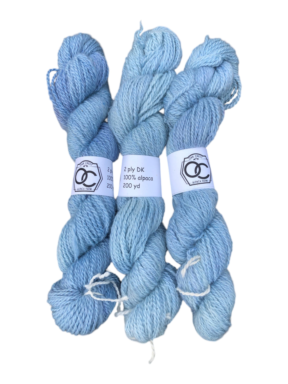 Three skeins of Oak Crest Alpacas and More hand-dyed light blue 100% American alpaca DK weight 2-ply yarn
