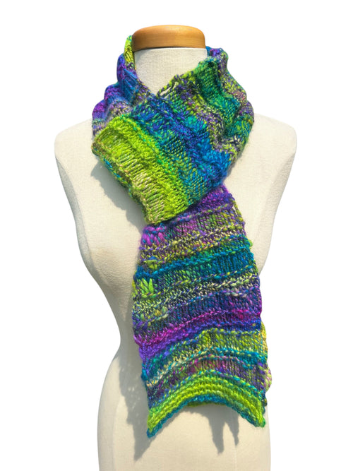 Oak Crest Alpacas and More hand-knit chunky alpaca scarf in vibrant purple, blue, and green lace design on mannequin