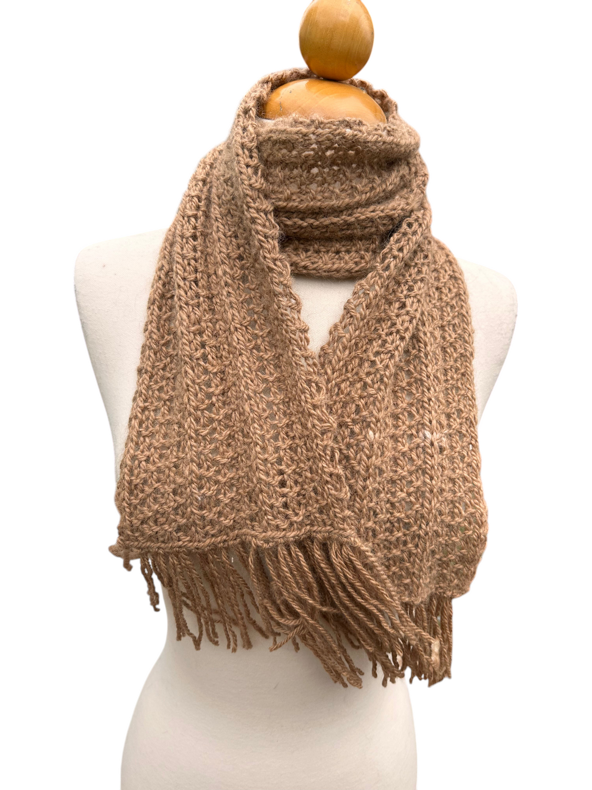Oak Crest Alpacas and More hand-knit tan alpaca wool scarf with fringe detail on a mannequin