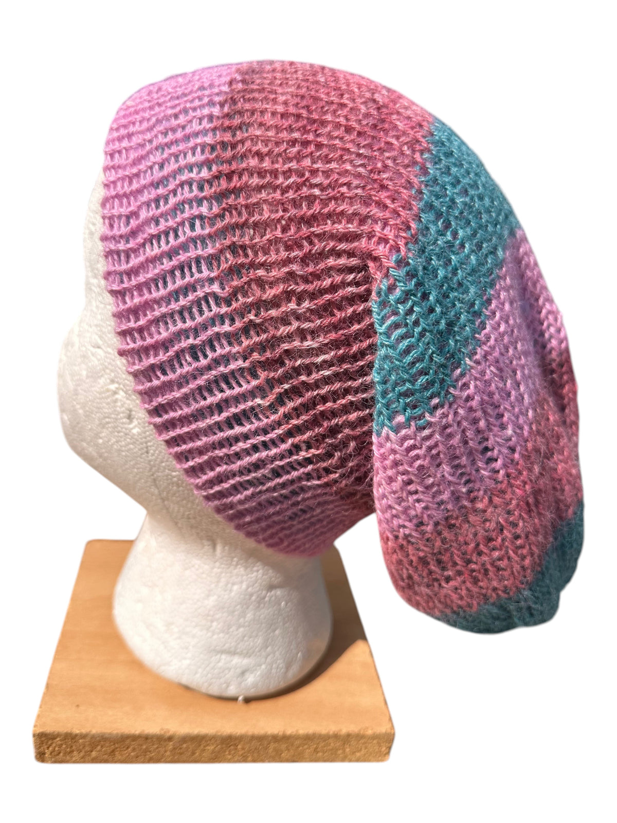 Oak Crest Alpacas and More lightweight double knit alpaca hat in pink and teal, shown on a mannequin head.
