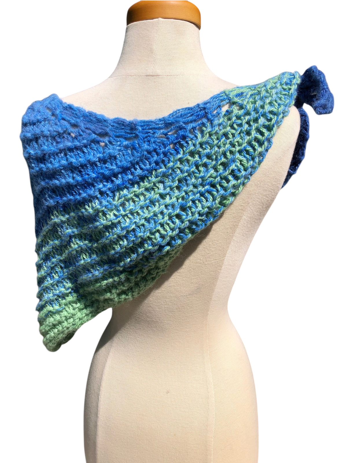 Oak Crest Alpacas and More hand knit alpaca shawl in blue and green ombre, styled with a knot on a mannequin.