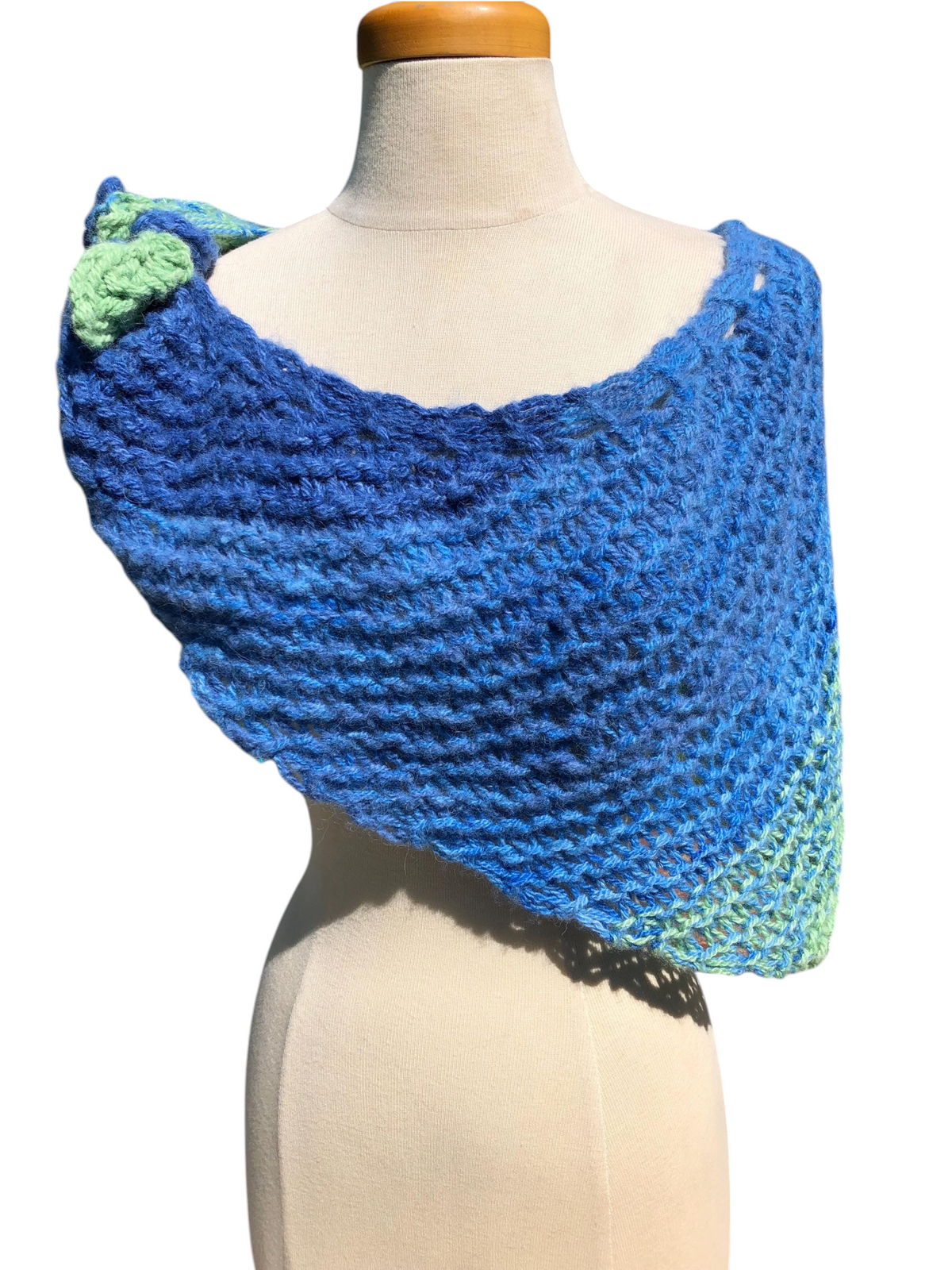 Oak Crest Alpacas and More hand knit alpaca shawl in blue and green ombre, styled with a knot on a mannequin.