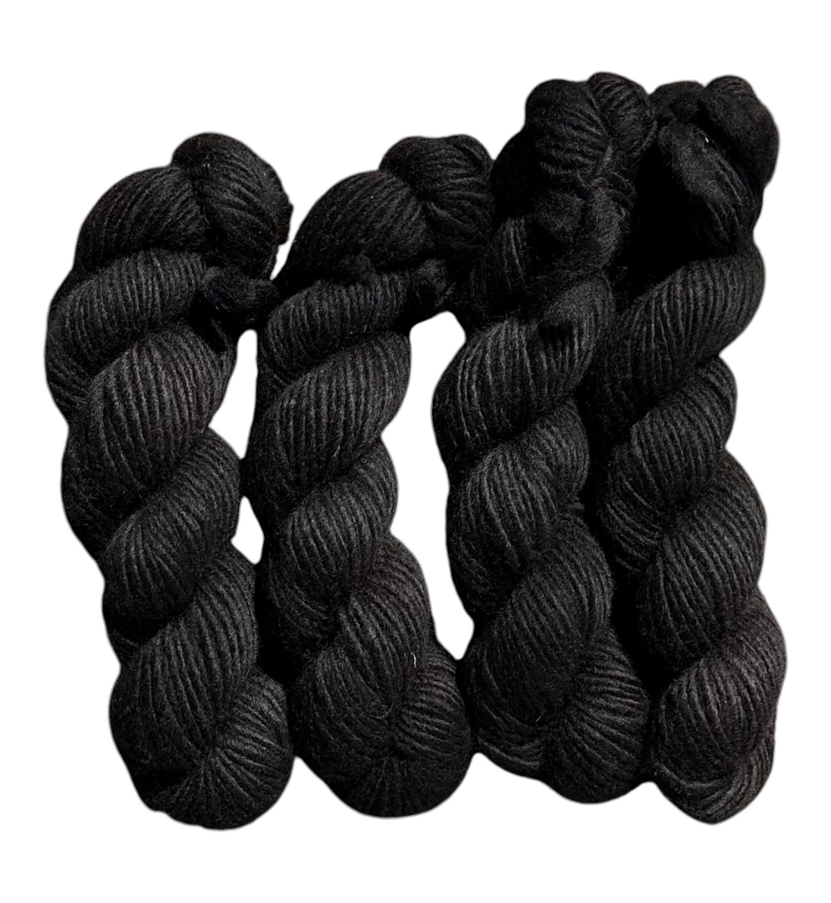 Oak Crest Alpacas and More black super bulky 1-ply dehaired alpaca yarn skeins with a rustic low twist texture.