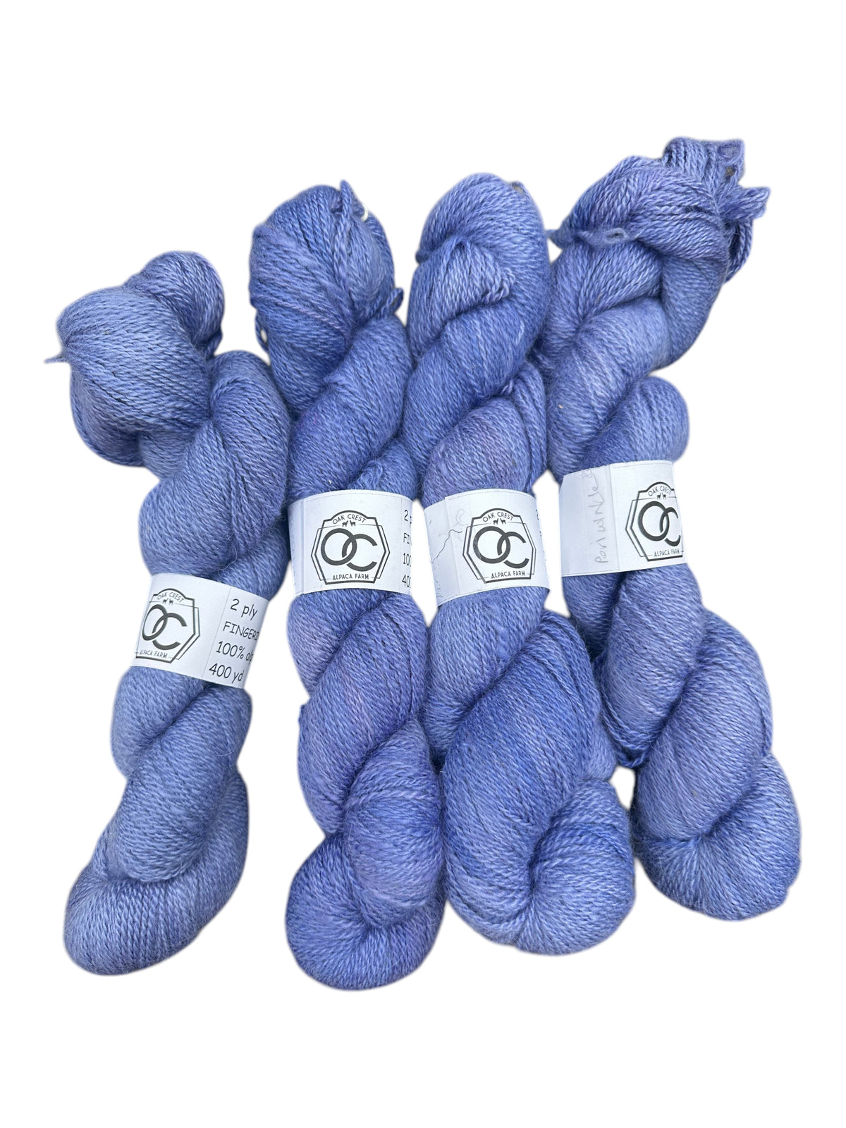 Four skeins of Oak Crest Alpacas and More hand-dyed periwinkle blue 100% American alpaca fingering weight yarn.