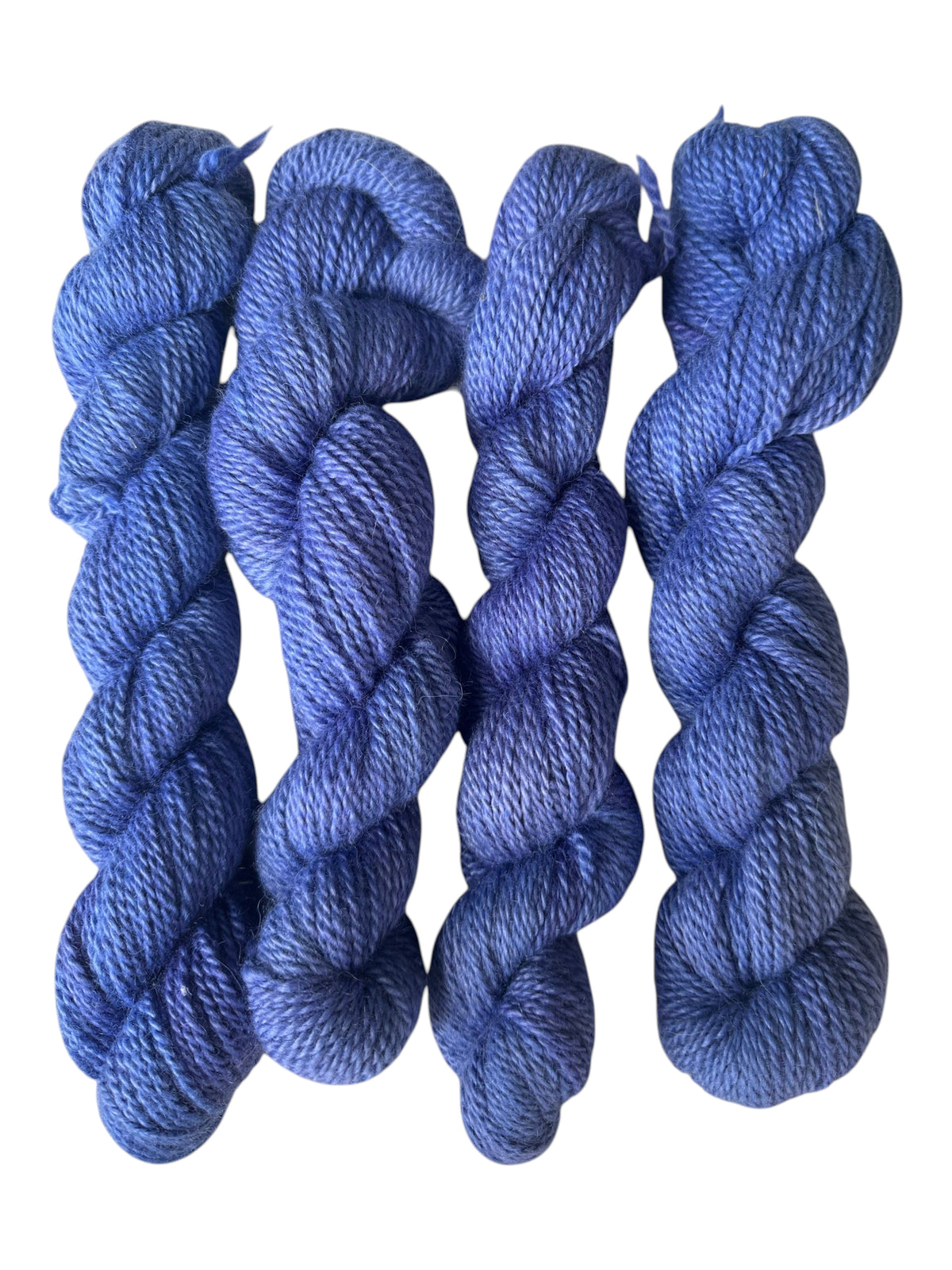 Oak Crest Alpacas and More hand-dyed blue worsted weight 100% alpaca yarn skeins with a soft 2-ply texture.