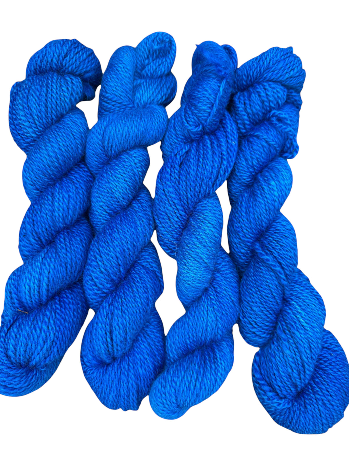 Oak Crest Alpacas and More hand-dyed royal blue worsted weight 100% alpaca yarn skeins with a soft 2-ply texture.