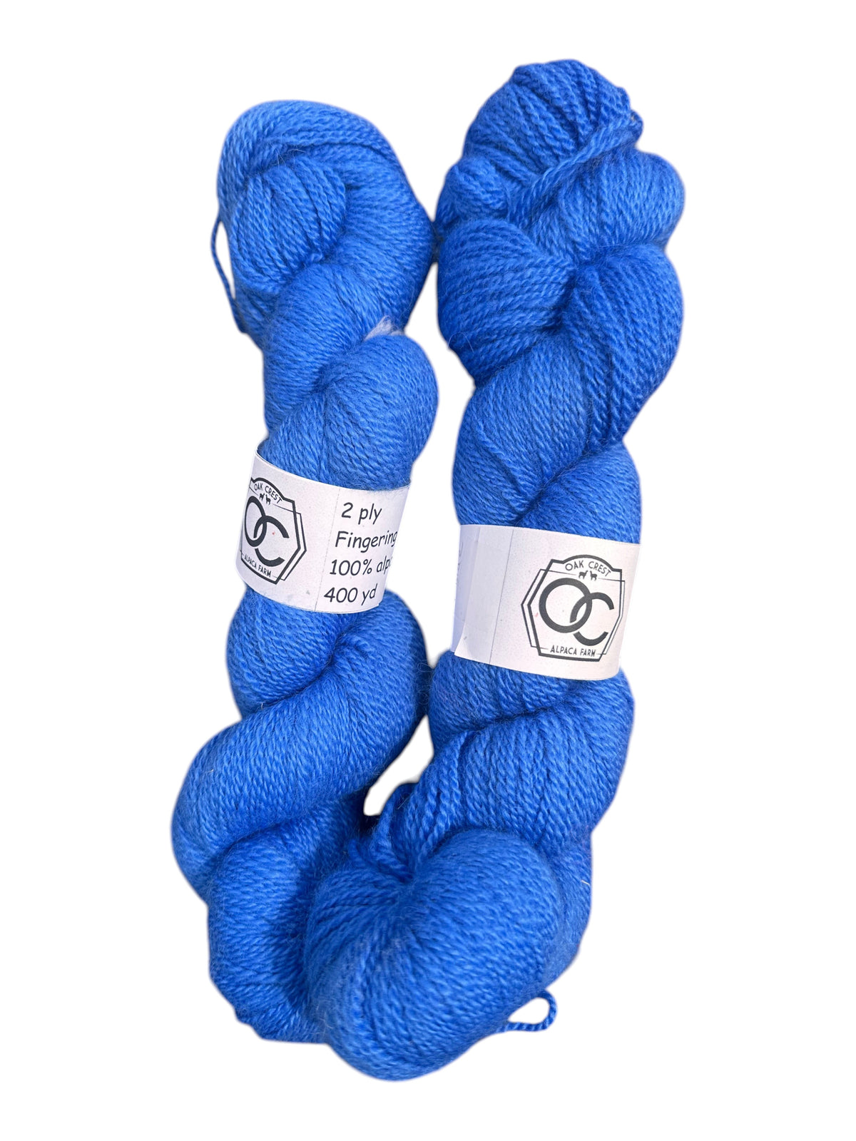 Two skeins of vibrant blue Oak Crest Alpacas and More hand-dyed 100% American alpaca fingering weight yarn.