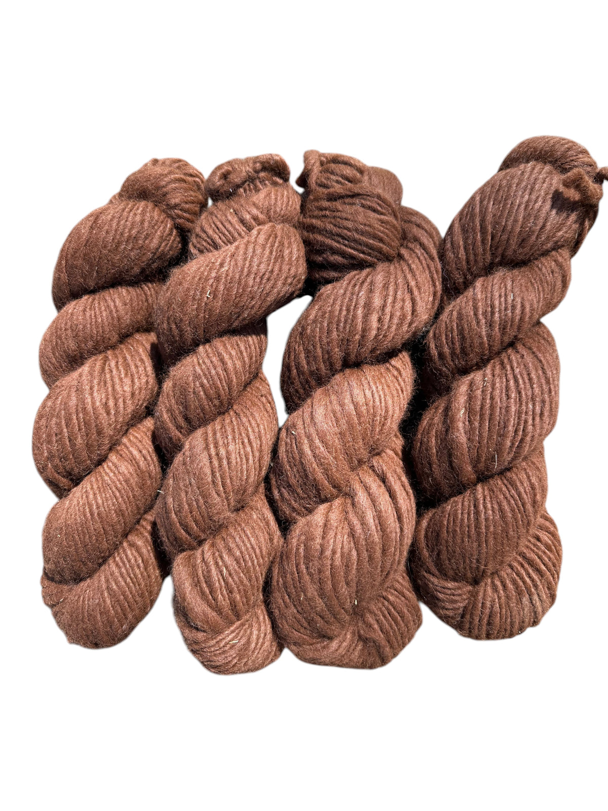 Oak Crest Alpacas and More medium brown super bulky single ply alpaca yarn skeins with a rustic low twist texture.