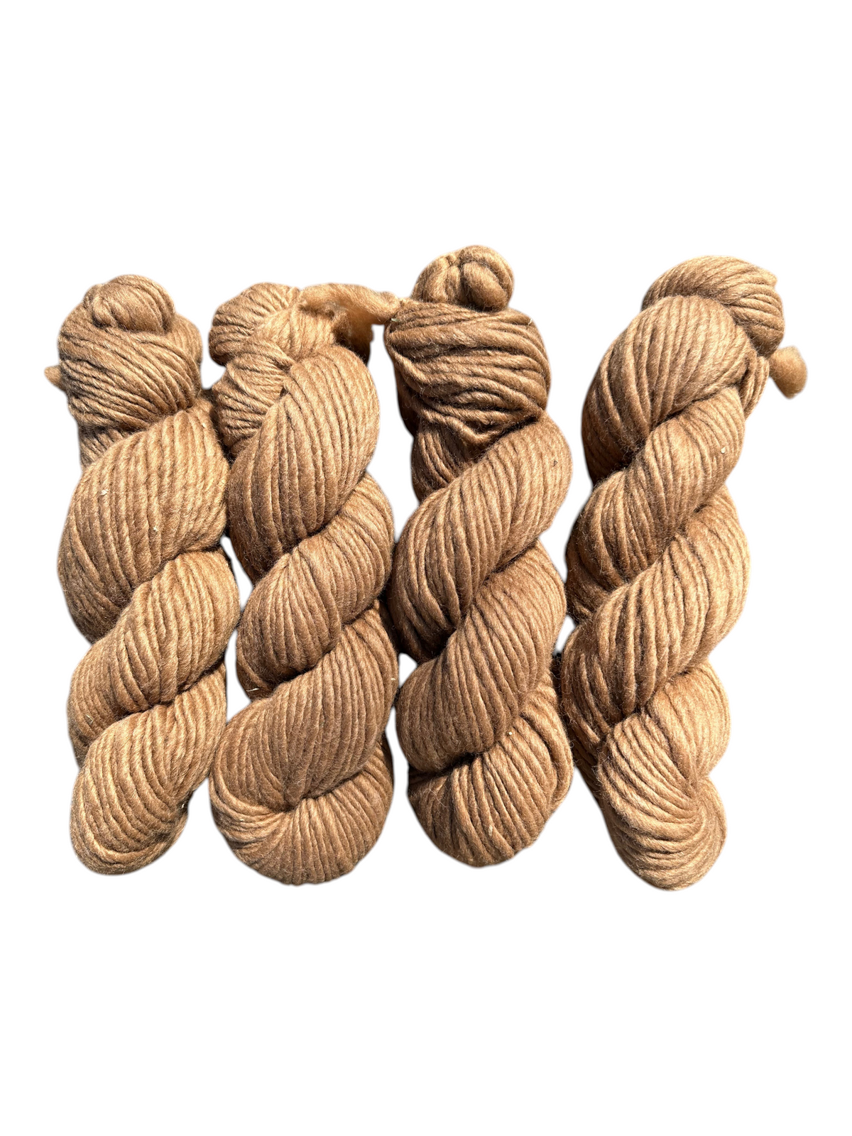 Four skeins of Oak Crest Alpacas and More super bulky, undyed medium brown alpaca yarn with a rustic, low-twist texture.