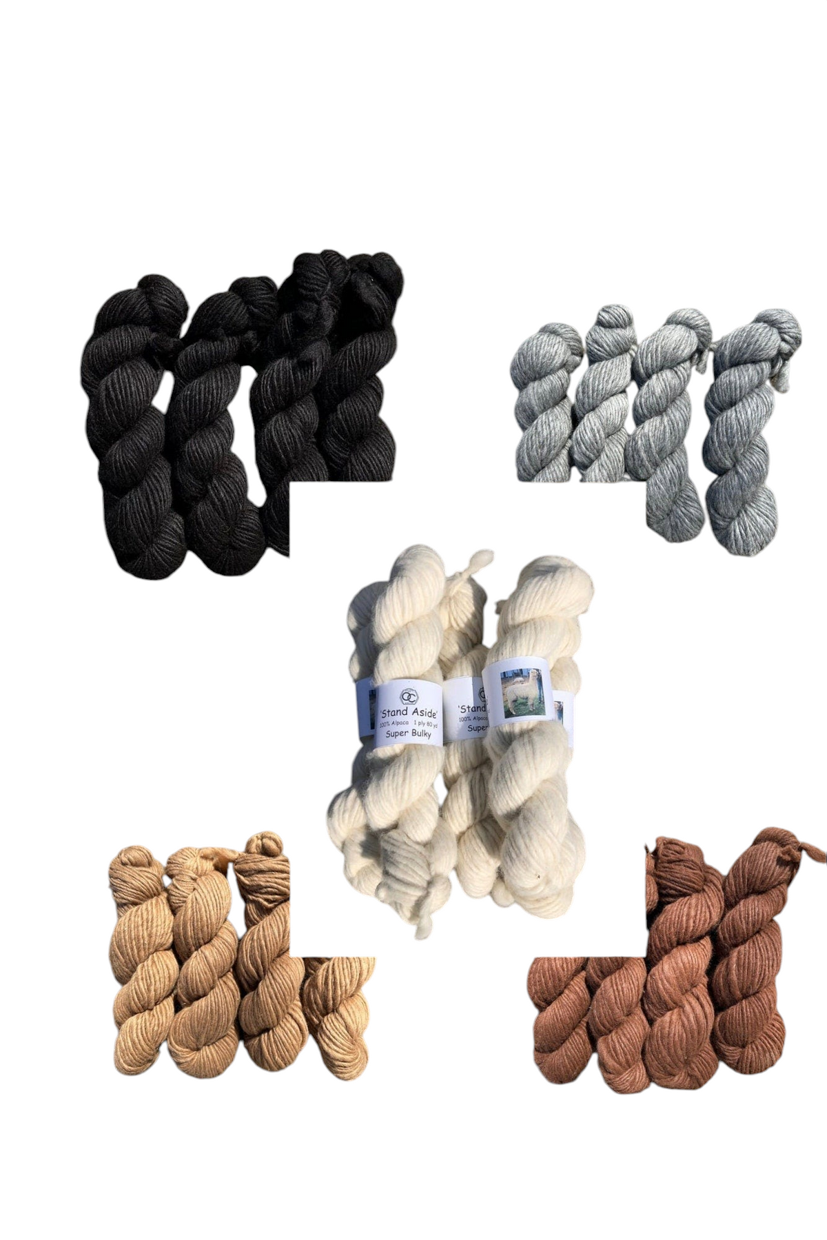 Oak Crest Alpacas and More super bulky 100% alpaca yarn skeins in natural undyed shades of white, black, gray, and brown.