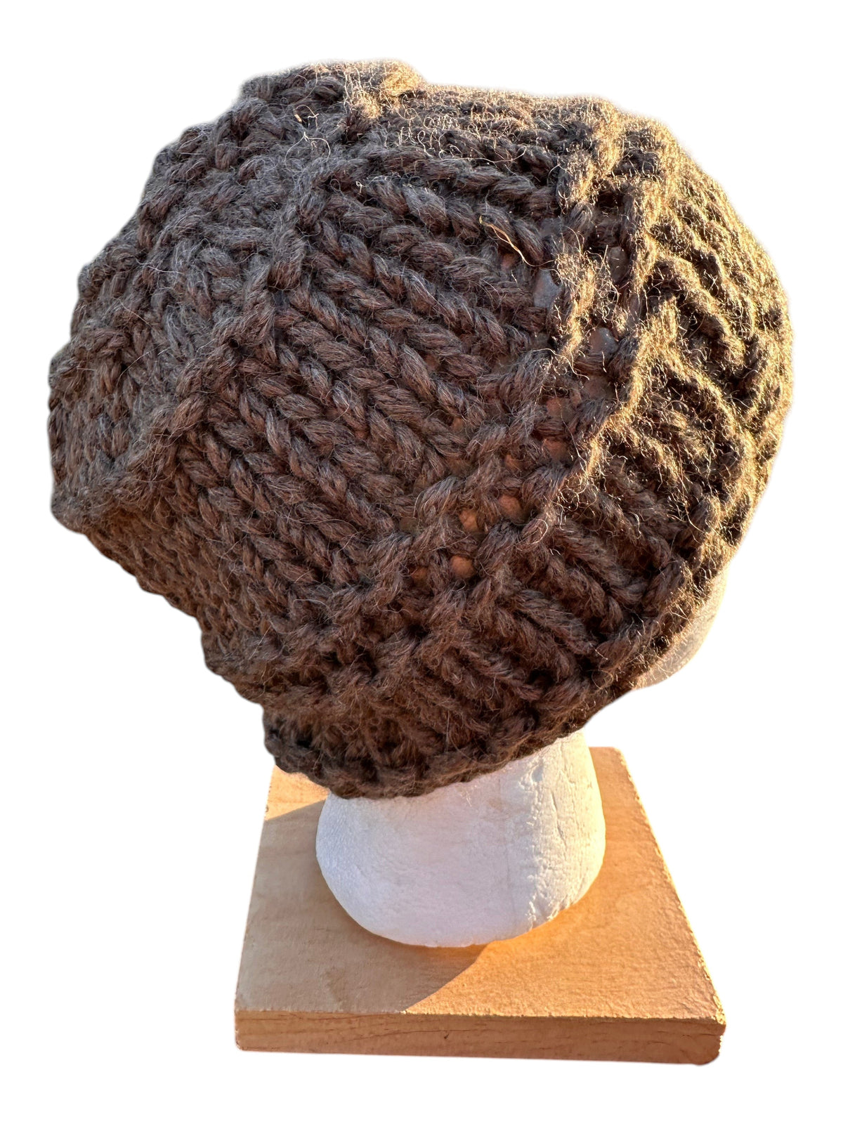 Oak Crest Alpacas and More hand-knit chunky brown alpaca wool hat with a textured lace pattern on a display head.