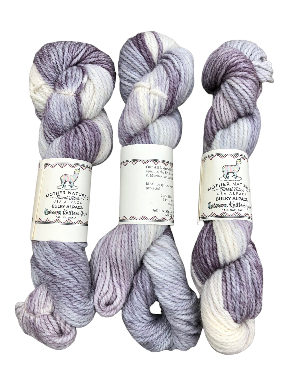 Oak Crest Alpacas and More chunky 3-ply yarn skeins in variegated purple, grey, and white alpaca and merino wool.