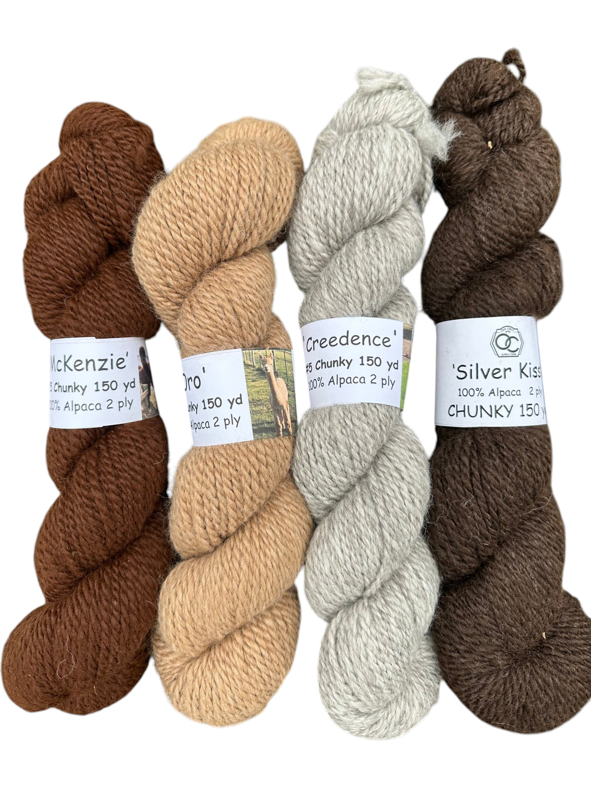 Oak Crest Alpacas and More chunky 2-ply alpaca yarn skeins in natural brown, fawn, silver gray, and black shades.