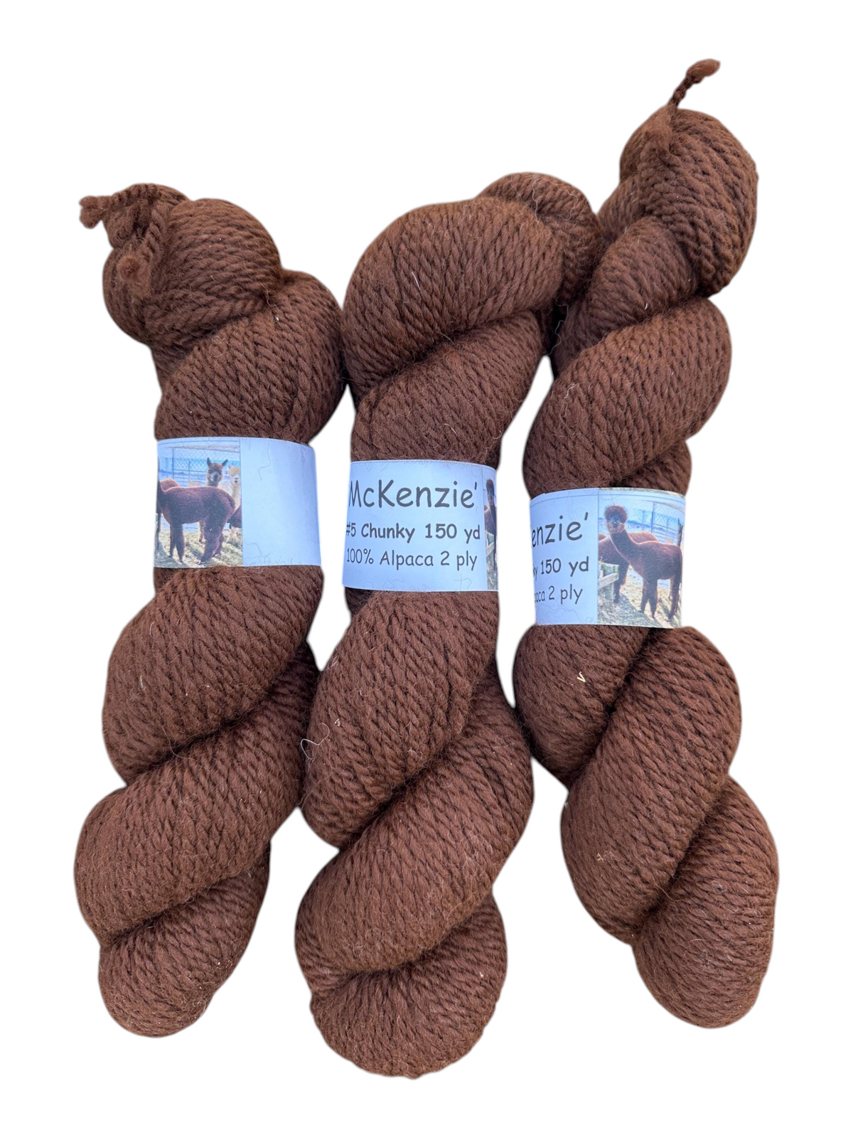 Three skeins of Oak Crest Alpacas and More chunky 2-ply medium brown alpaca yarn with McKenzie labels