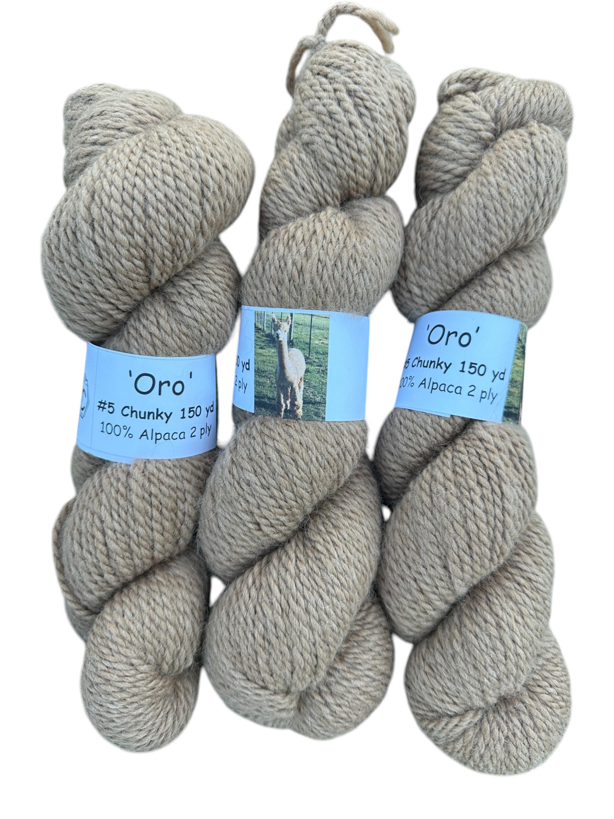 Oak Crest Alpacas and More chunky 2-ply natural fawn alpaca yarn skeins labeled Oro