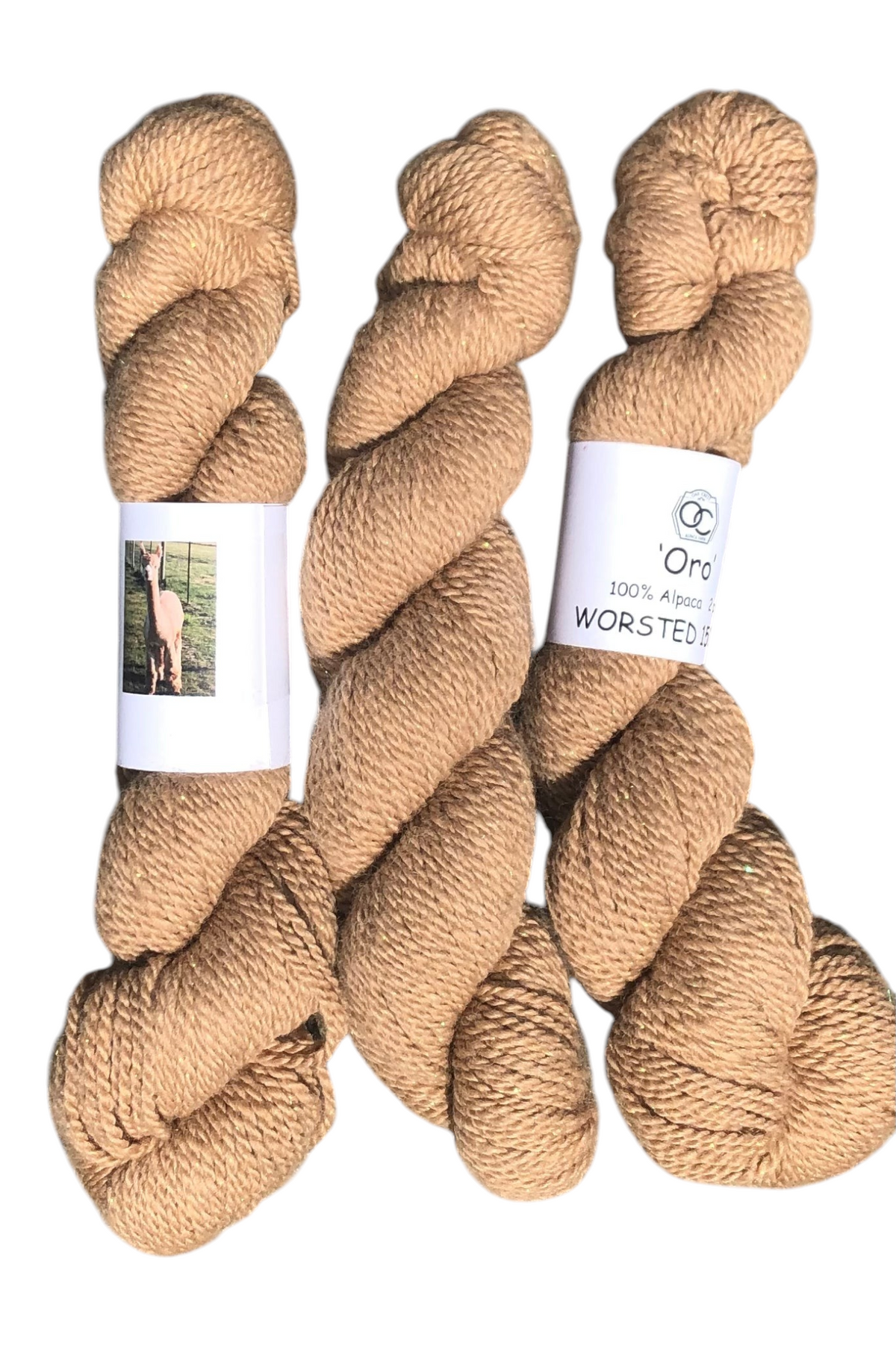Oak Crest Alpacas and More worsted 100% alpaca yarn in medium fawn Oro color, two skeins with labels.