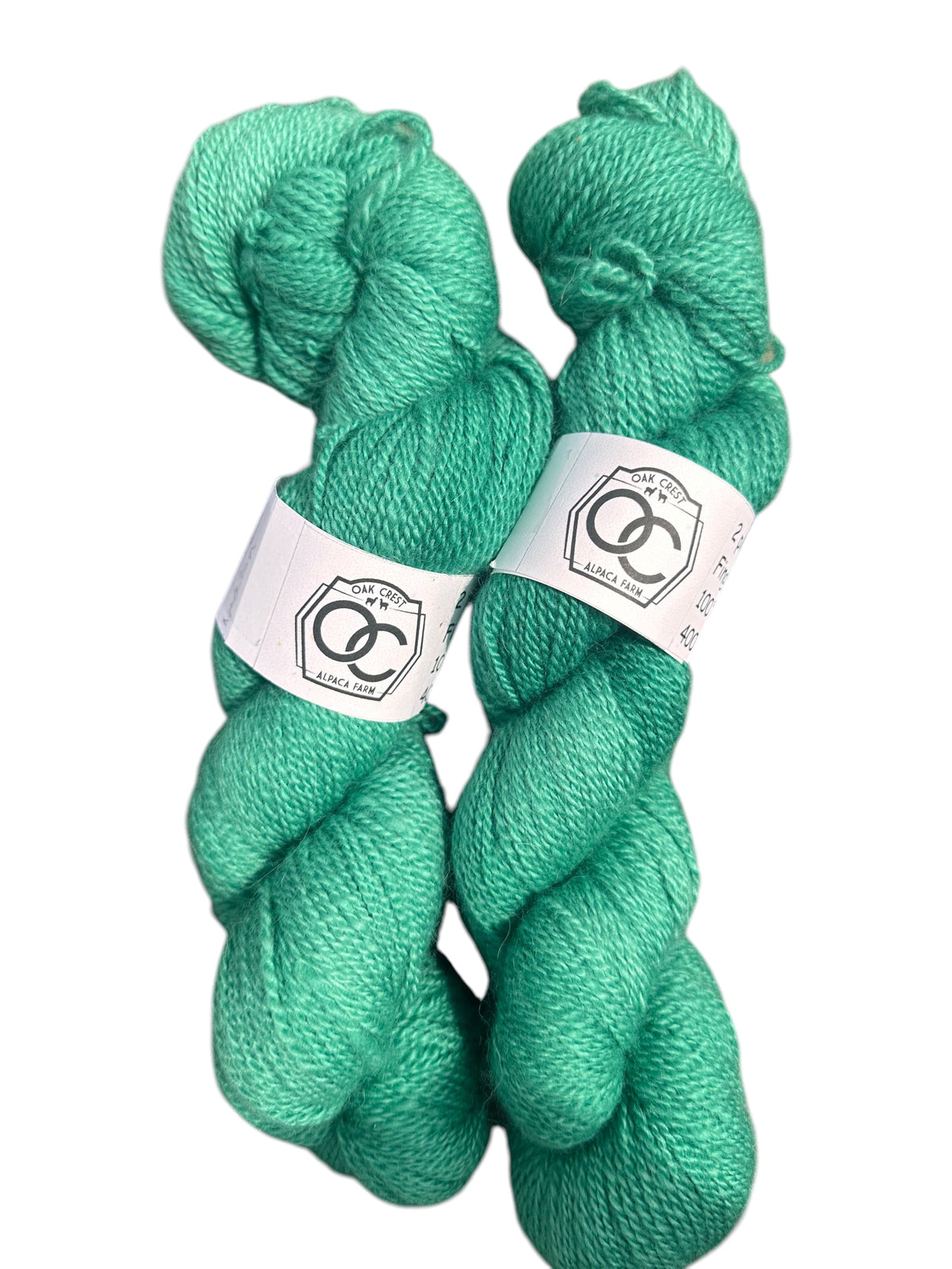 Two skeins of Oak Crest Alpacas and More hand-dyed green 100% American alpaca fingering weight yarn