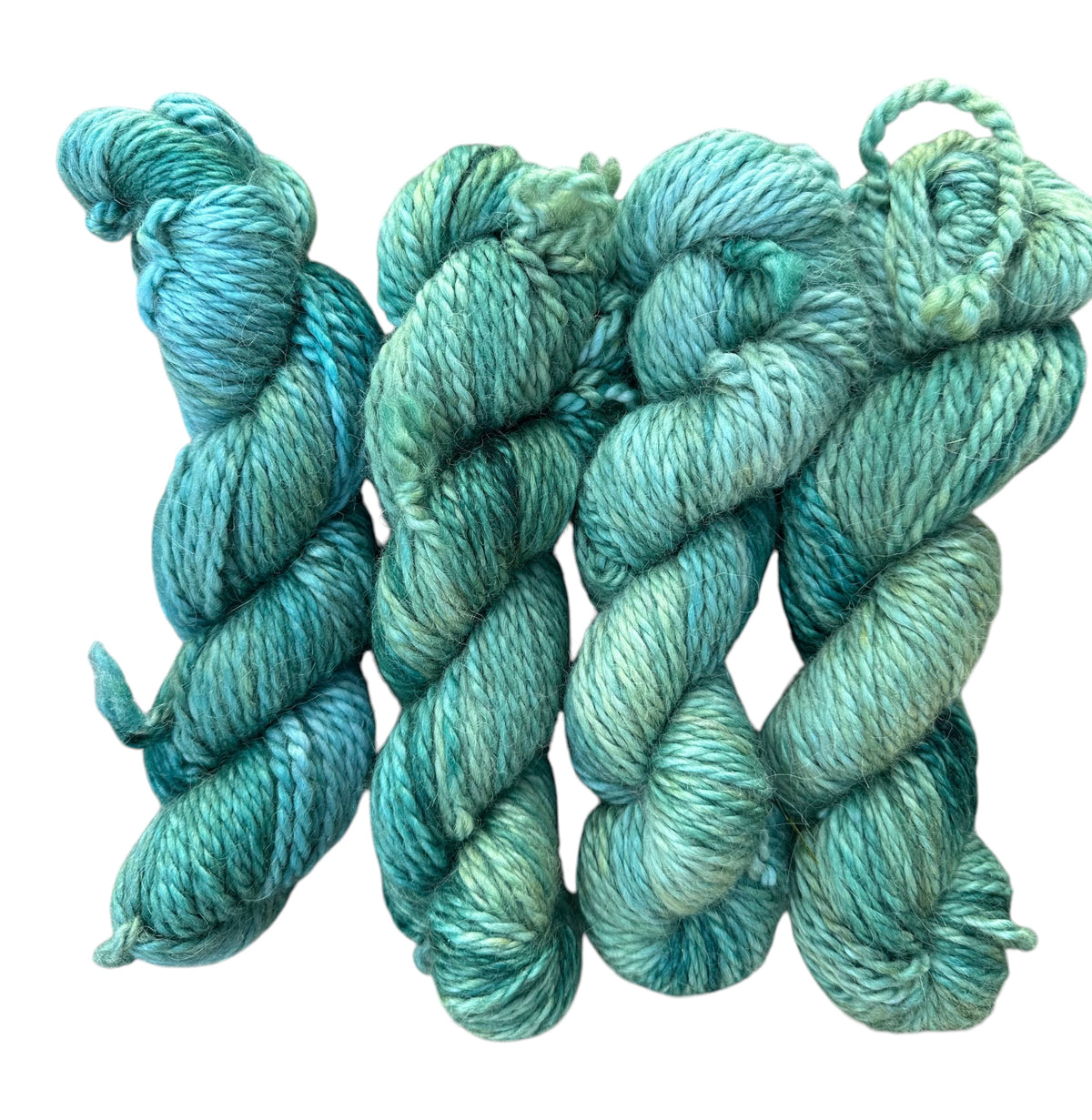 Oak Crest Alpacas and More hand dyed 100% alpaca yarn in Forrest Green with variegated teal and blue tones