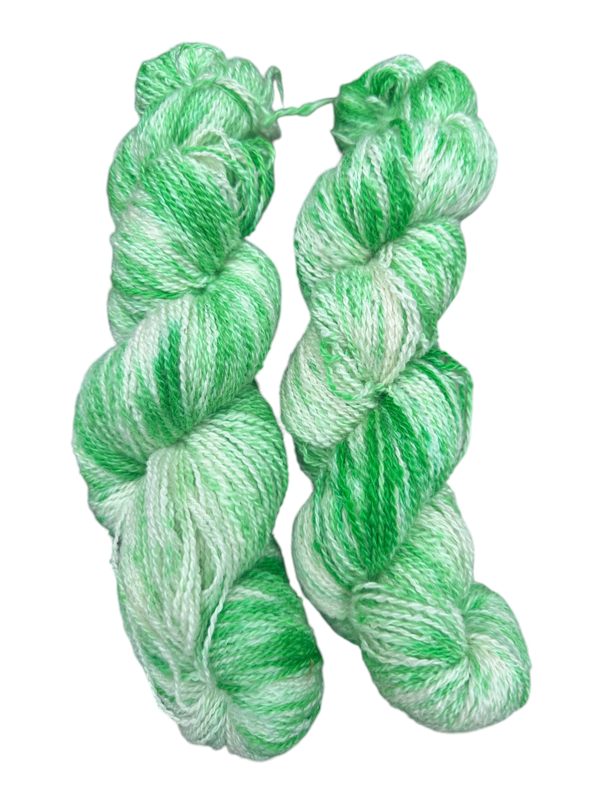 Oak Crest Alpacas and More hand-dyed fingering weight alpaca yarn skeins in variegated shades of green and white.