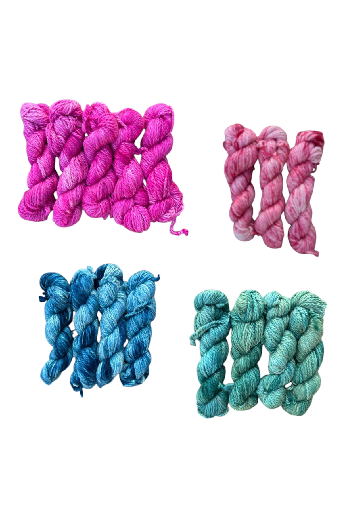 Oak Crest Alpacas and More hand dyed 100% alpaca yarn skeins in ruby red, indigo blue, forest green, and pink orchid.