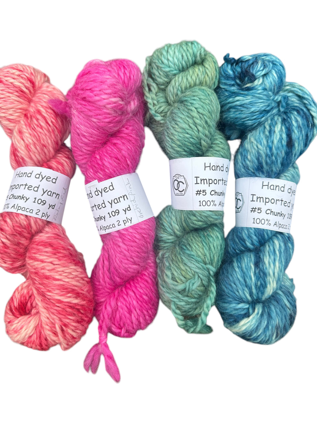 Oak Crest Alpacas and More hand dyed 100% alpaca chunky yarn in ruby red, pink orchid, forest green, and indigo blue.