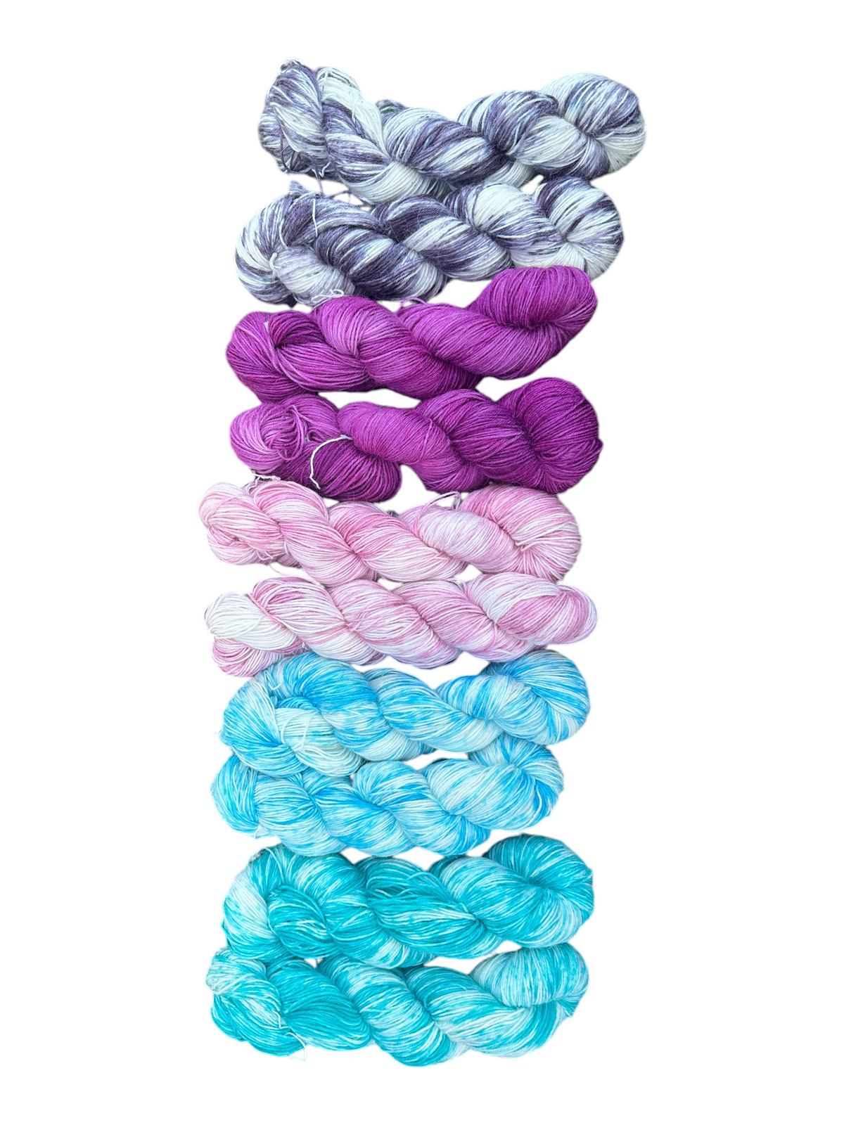 Oak Crest Alpacas and More hand-dyed alpaca nylon fingering weight sock yarn skeins in purple, pink, and blue tones.
