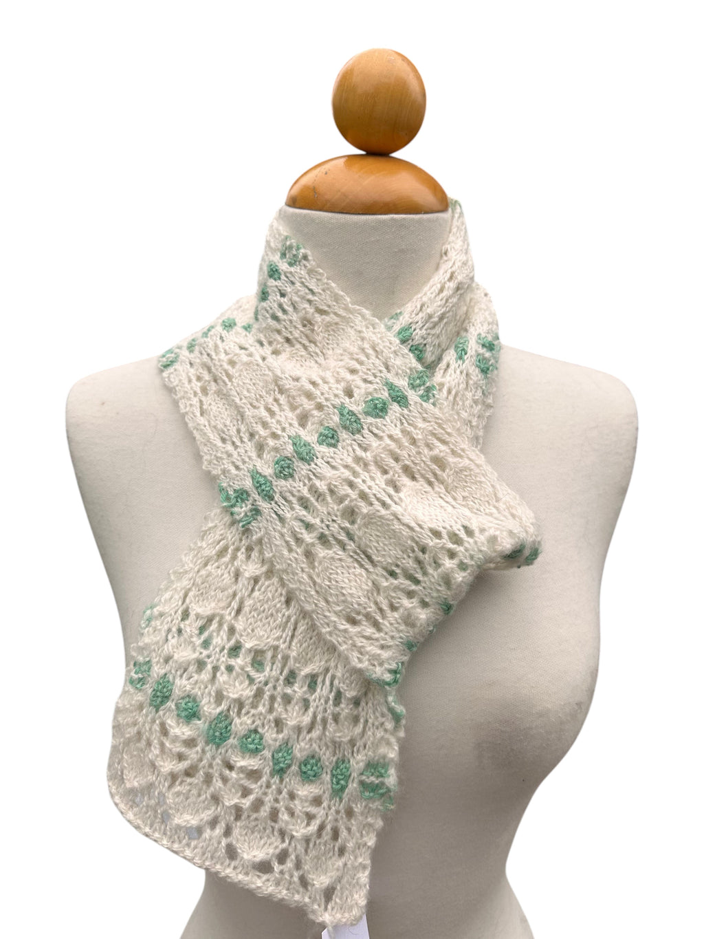Oak Crest Alpacas and More hand knit white and green lace alpaca scarf on a mannequin