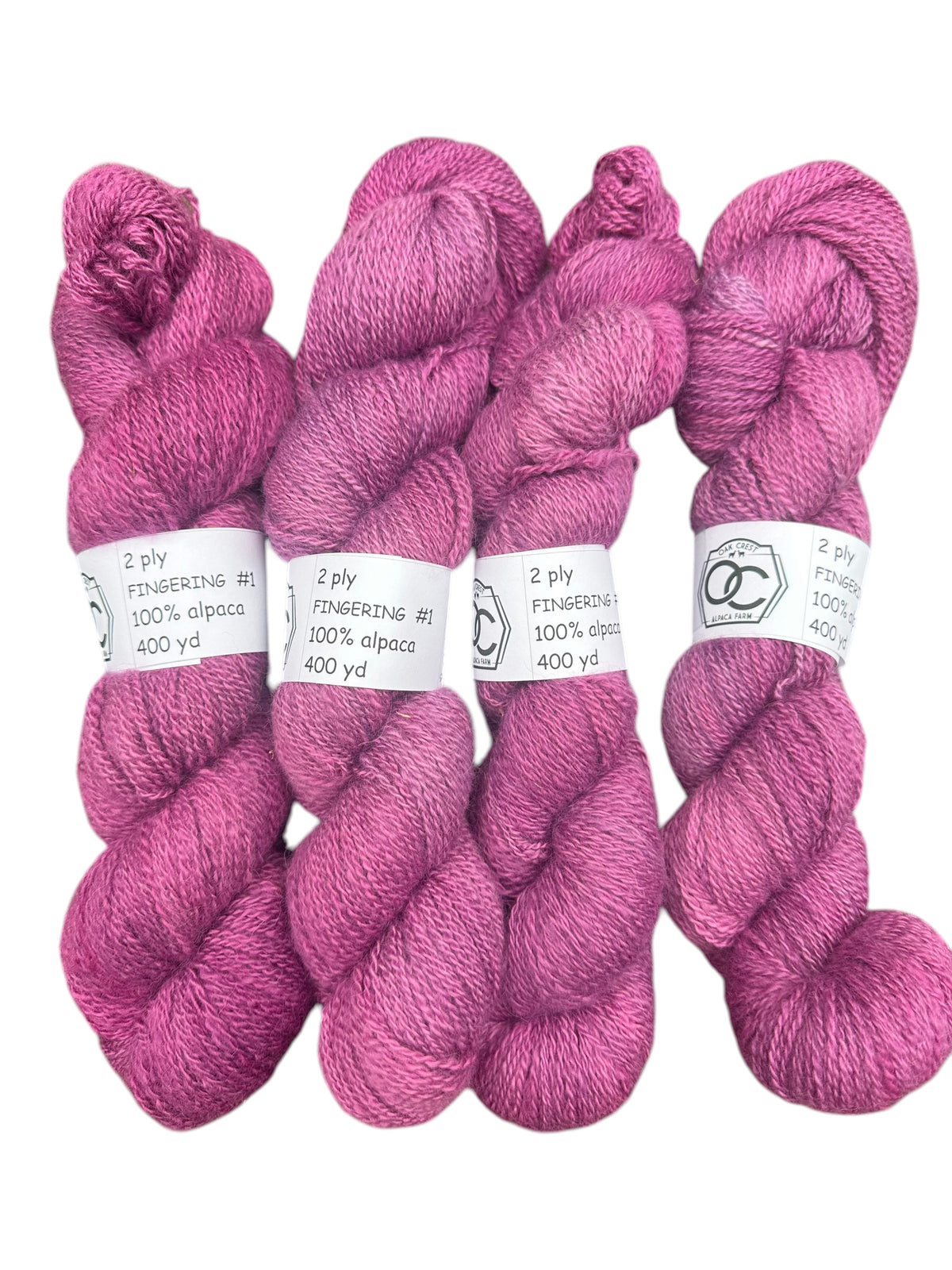 Oak Crest Alpacas and More hand-dyed magenta 100% alpaca fingering weight yarn skeins with white labels
