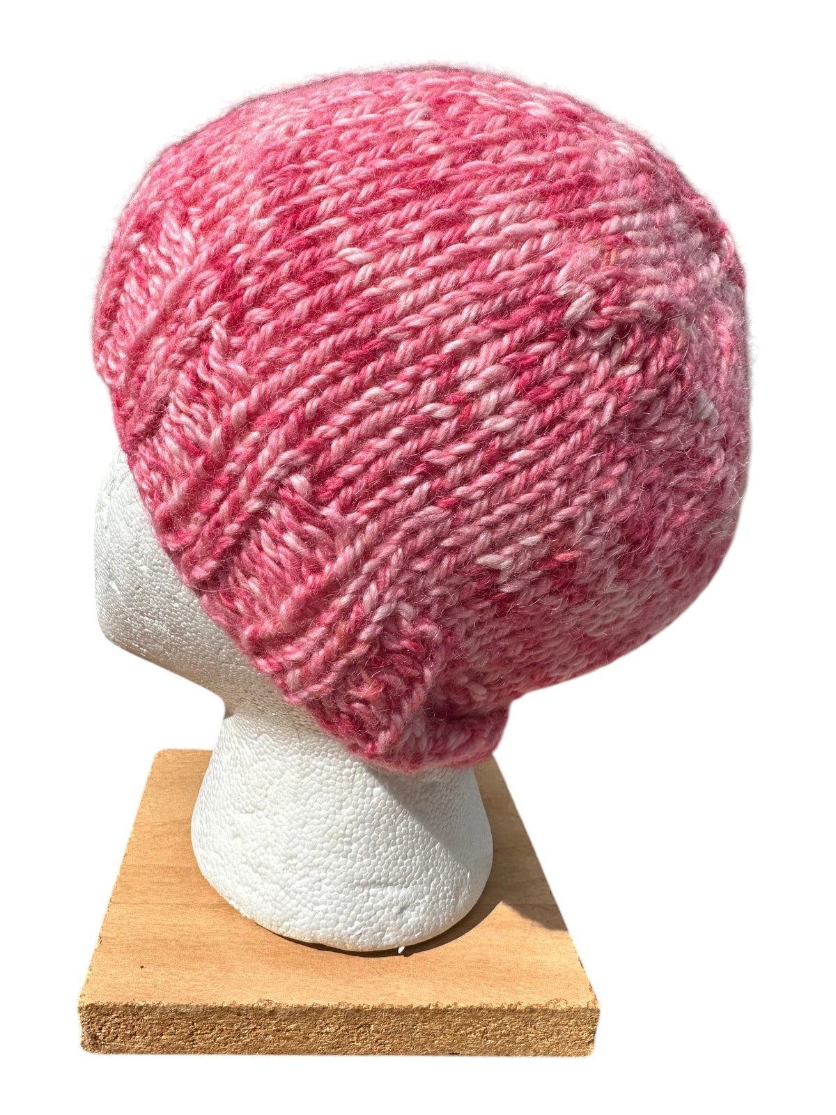 Oak Crest Alpacas and More hand-knit chunky winter hat in variegated shades of pink alpaca yarn on a display head.