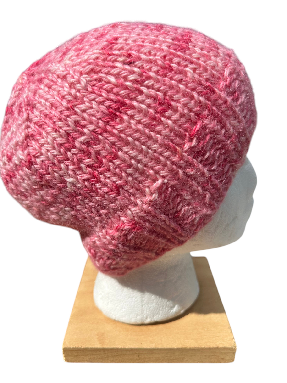 Oak Crest Alpacas and More hand-knit chunky winter hat in variegated shades of pink alpaca yarn on a mannequin head.
