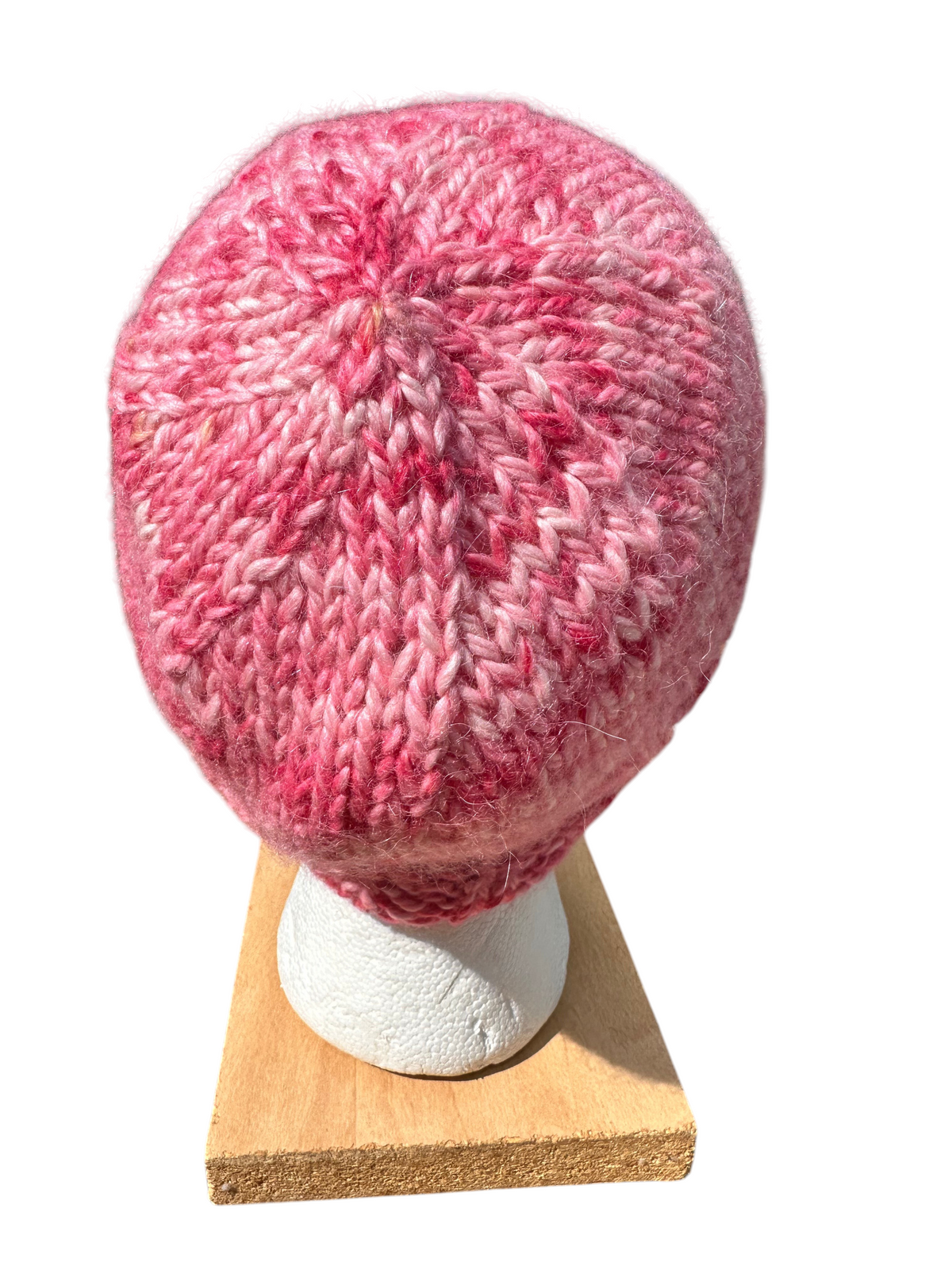 Oak Crest Alpacas and More hand knit chunky alpaca winter hat in variegated shades of pink on a display stand