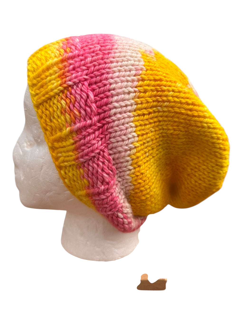 Oak Crest Alpacas and More hand knit pink and yellow alpaca wool slouch beanie hat on a mannequin head