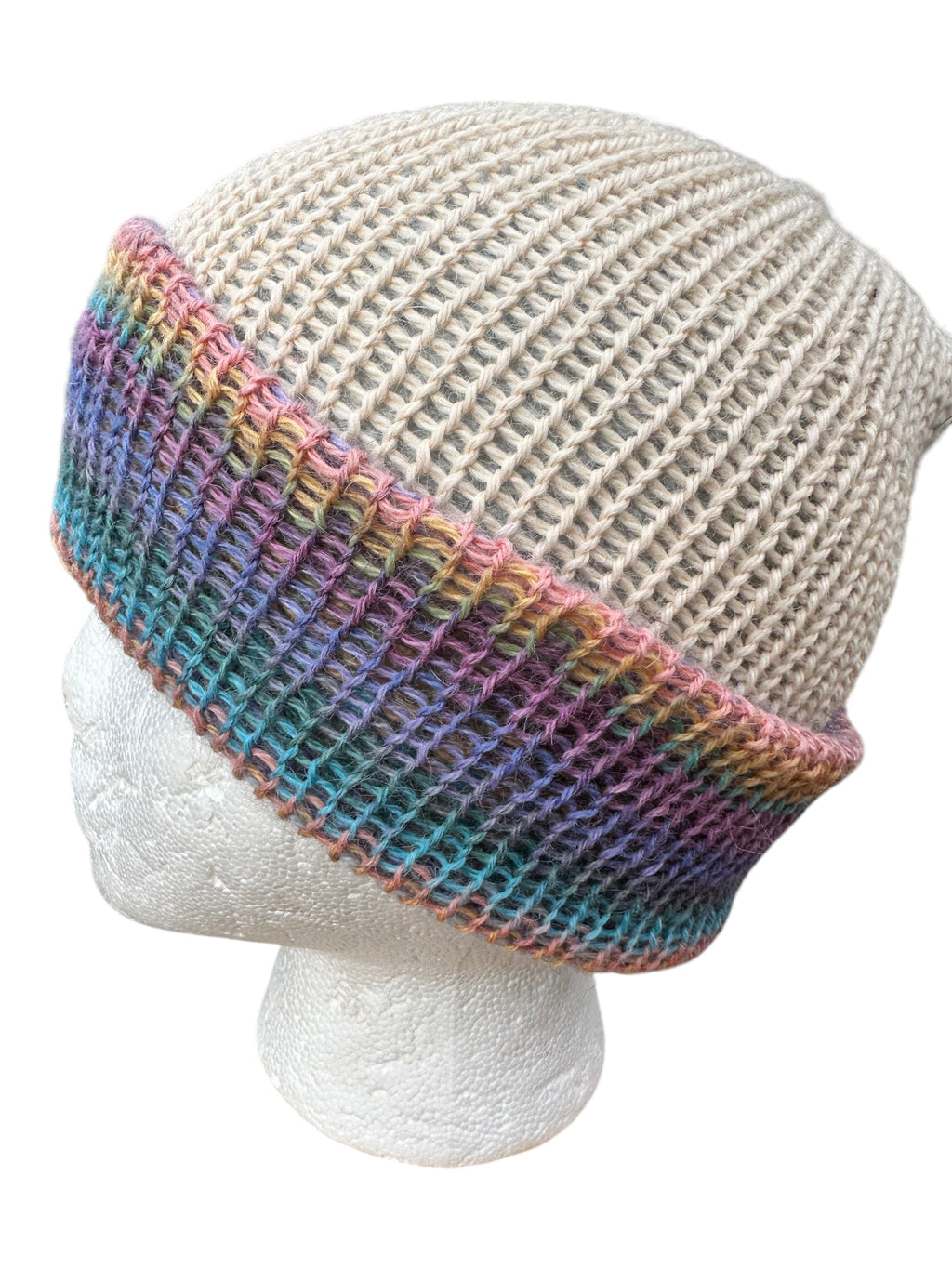 Oak Crest Alpacas and More reversible double knit alpaca hat with a beige crown and a colorful multi-tone fold-over brim