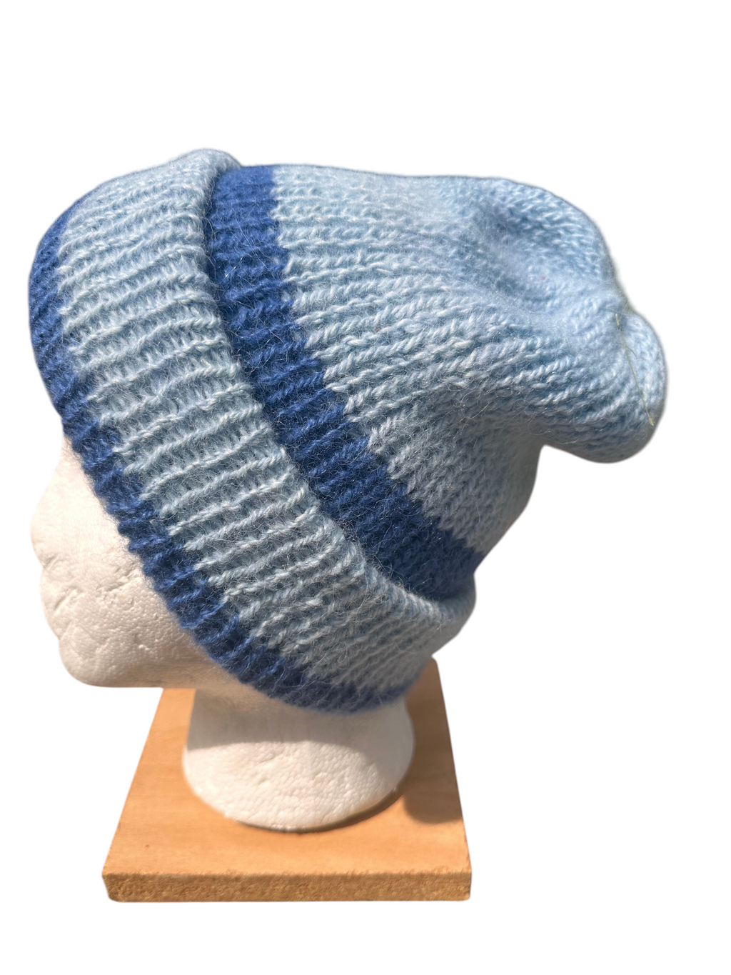 Oak Crest Alpacas and More reversible double knit alpaca hat in light and dark blue stripes on a mannequin head