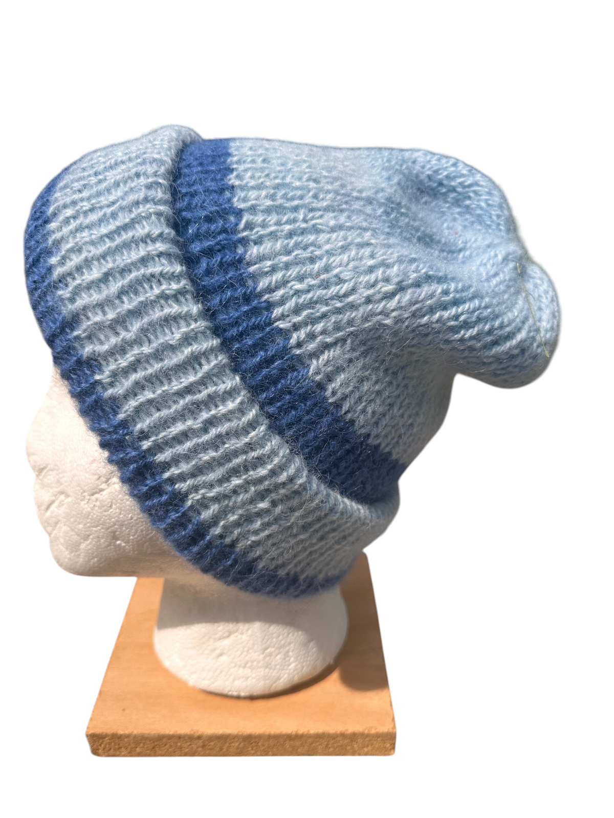 Oak Crest Alpacas and More reversible double knit alpaca hat in light and dark blue stripes on a mannequin head