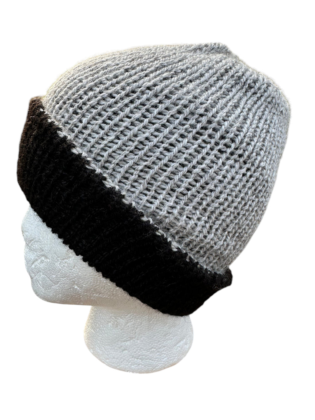 Oak Crest Alpacas and More reversible double knit alpaca hat in grey and black with a folded brim on a mannequin
