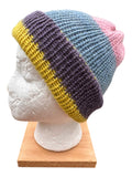 Oak Crest Alpacas and More reversible double knit alpaca hat in purple, yellow, blue, and pink on a mannequin head.