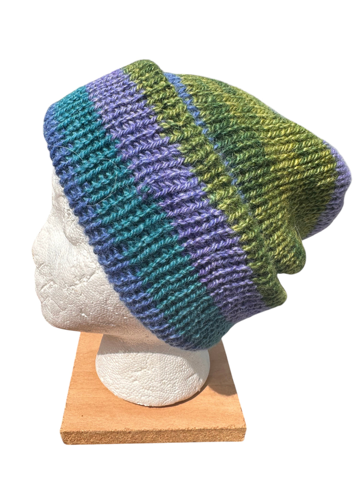 Oak Crest Alpacas and More reversible double knit alpaca hat in variegated green, blue, and purple on mannequin head