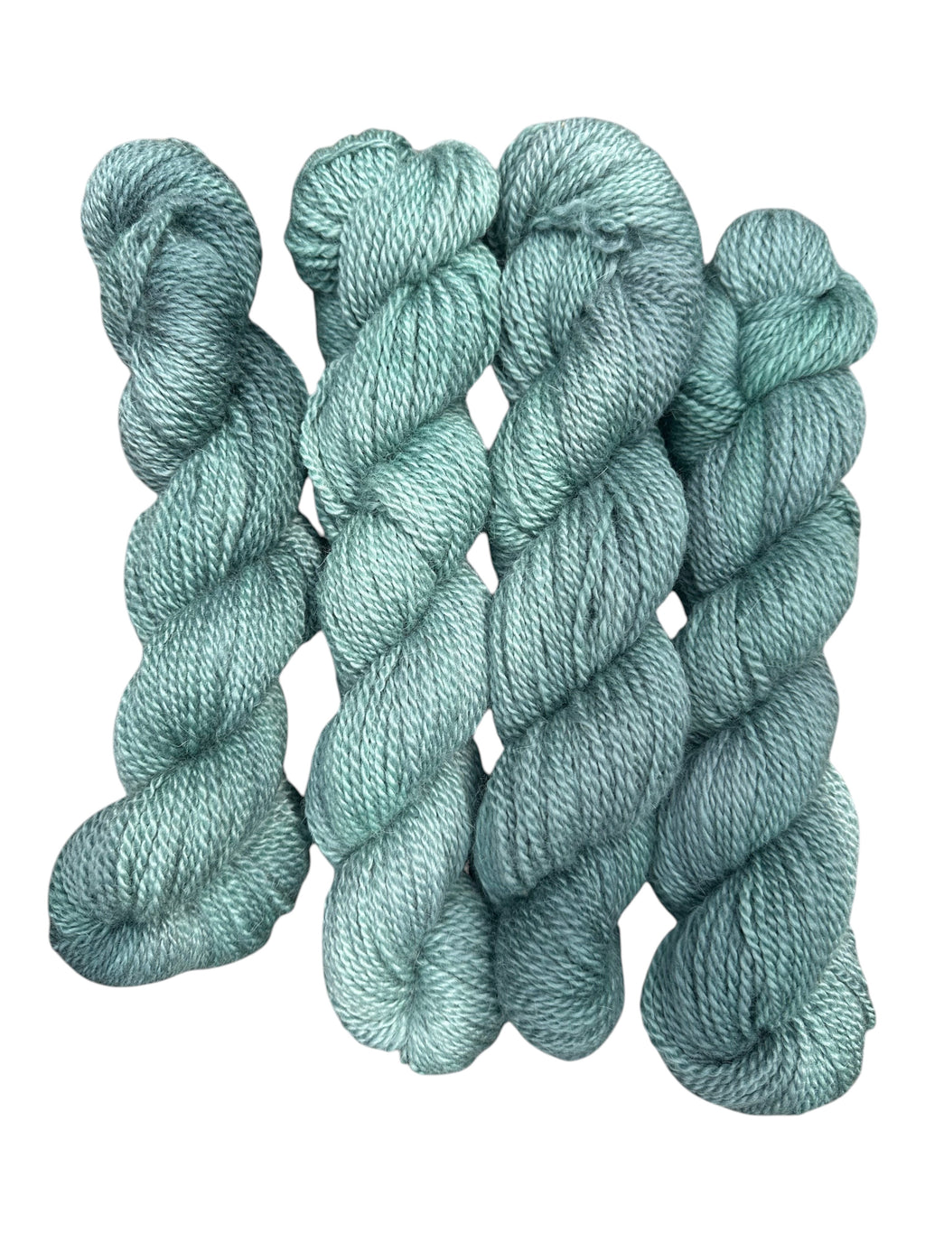 Oak Crest Alpacas and More hand-dyed worsted weight 100% American alpaca yarn in a soft sage green 2-ply skein.
