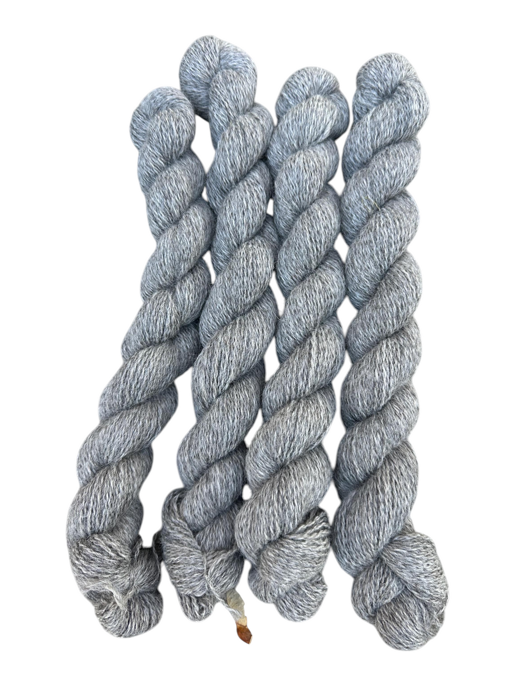 Oak Crest Alpacas and More medium silver gray fingering weight alpaca yarn skeins, undyed and dehaired natural fiber.